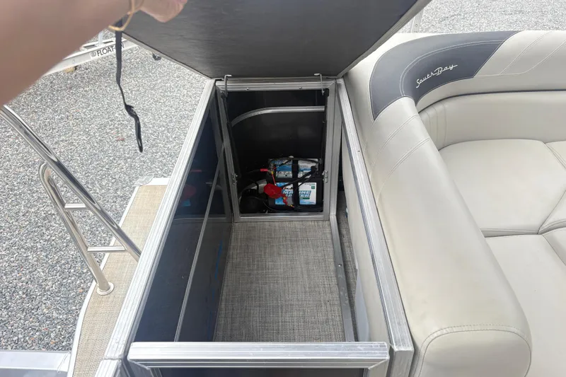 Slide: The Image of 2022 South Bay LE boat storage compartment with battery and seating. - 13