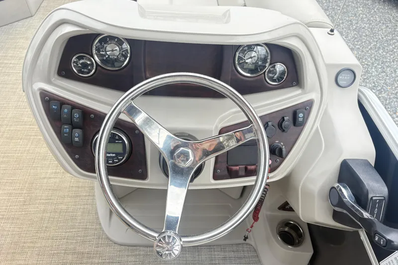 Slide: The Image of Steering console of a 2022 South Bay LE boat with gauges and controls. - 14