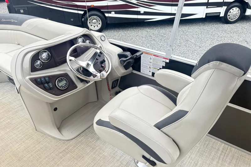 Slide: The Image of Captain's chair and helm of 2022 South Bay LE boat, featuring modern controls and steering wheel. - 15