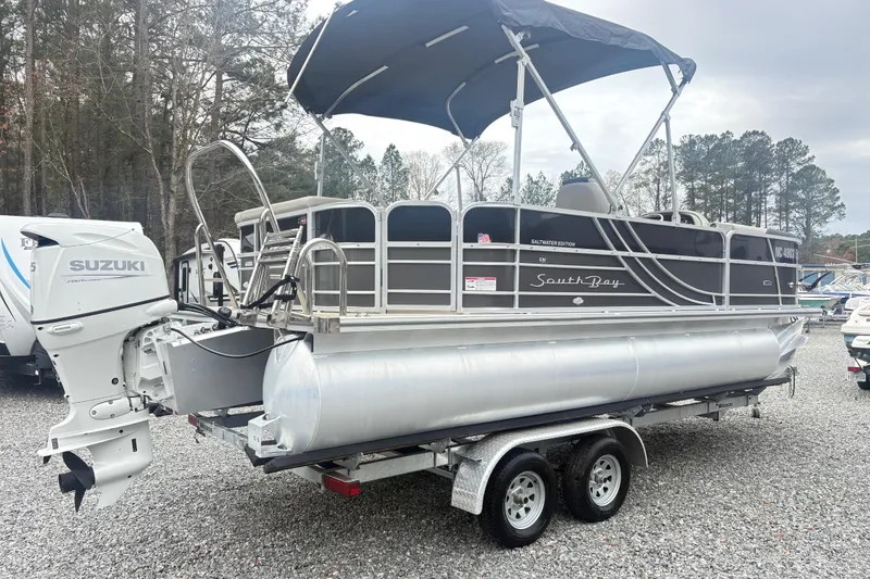 Slide: The Image of 2022 South Bay LE pontoon boat with Suzuki outboard motor on a trailer. - 3