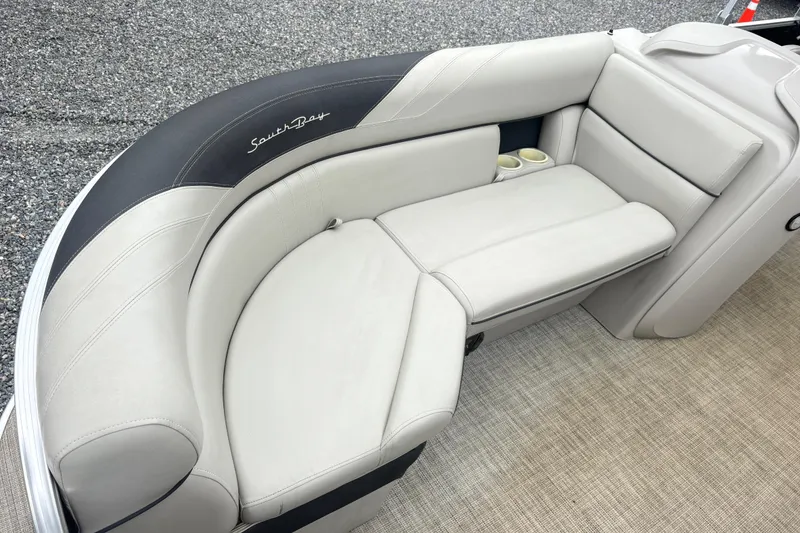 Slide: The Image of 2022 South Bay LE boat seating with beige upholstery and cup holders. - 7