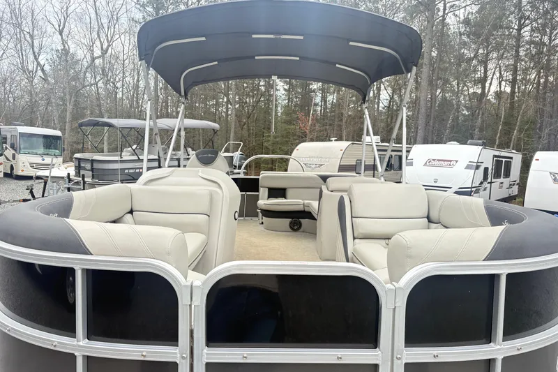 Slide: The Image of 2022 South Bay LE pontoon boat with spacious seating and canopy in a wooded area. - 9