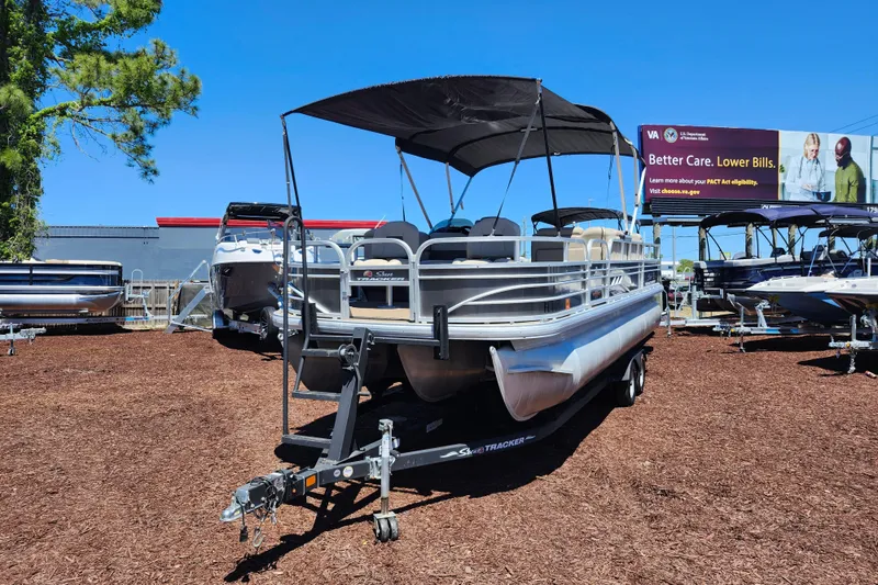 The Image of 2023 Sun Tracker Fishin' Barge 22 XP3 pontoon boat on display outdoors. - 1
