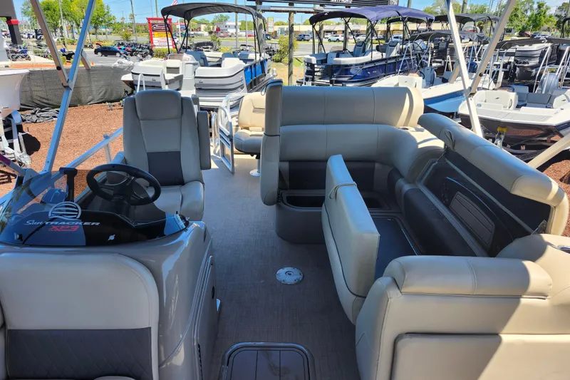 Slide: The Image of 2023 Sun Tracker Fishin' Barge 22 XP3 interior with plush seating and steering console. - 10