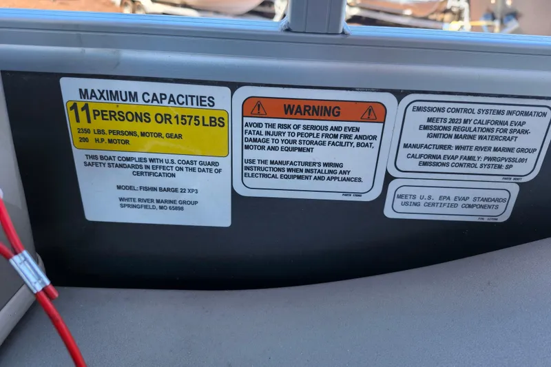 Slide: The Image of 2023 Sun Tracker Fishin' Barge 22 XP3 capacity and safety warning labels. - 11