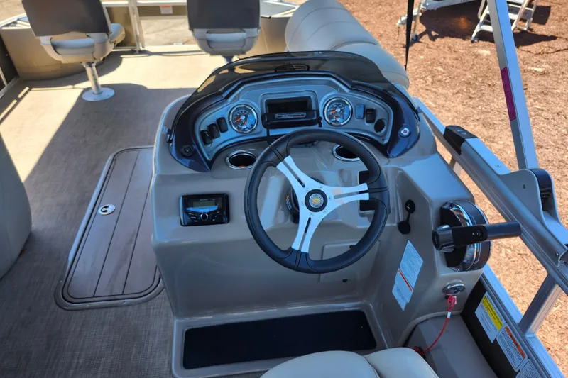 Slide: The Image of 2023 Sun Tracker Fishin' Barge 22 XP3 steering console with gauges and controls. - 12