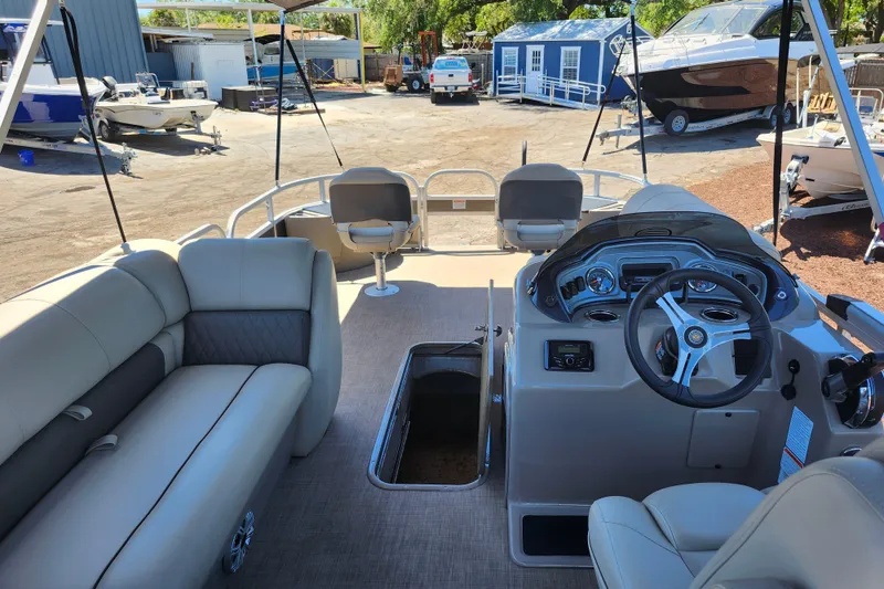 Slide: The Image of 2023 Sun Tracker Fishin' Barge 22 XP3 interior with seating and steering console. - 15