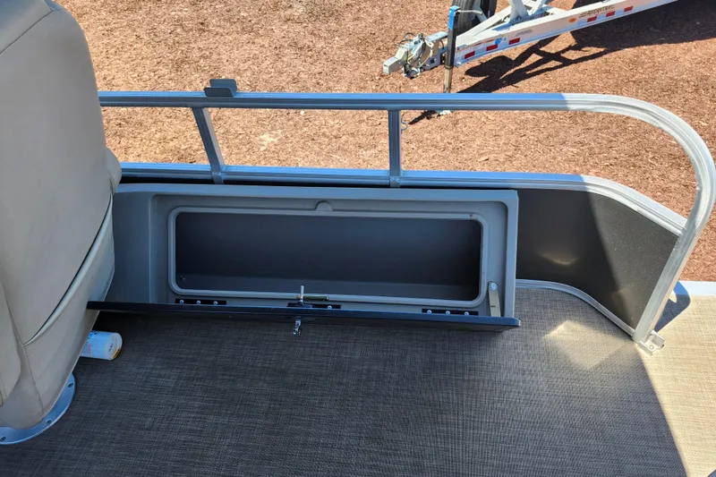 Slide: The Image of 2023 Sun Tracker Fishin' Barge 22 XP3 storage compartment with open hatch on deck. - 16