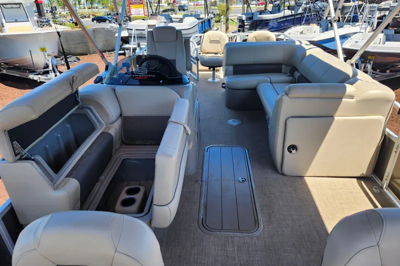 Slide: The Image of 2023 Sun Tracker Fishin' Barge 22 XP3 interior with spacious seating and storage compartments. - 17