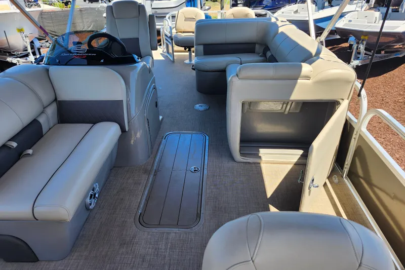 Slide: The Image of 2023 Sun Tracker Fishin' Barge 22 XP3 interior with spacious seating and storage. - 19