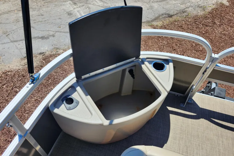 Slide: The Image of 2023 Sun Tracker Fishin' Barge 22 XP3 storage compartment with cup holders. - 22