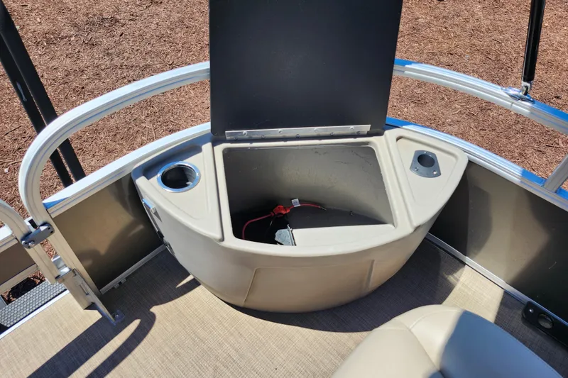 Slide: The Image of 2023 Sun Tracker Fishin' Barge 22 XP3 storage compartment with cup holders and wiring. - 23