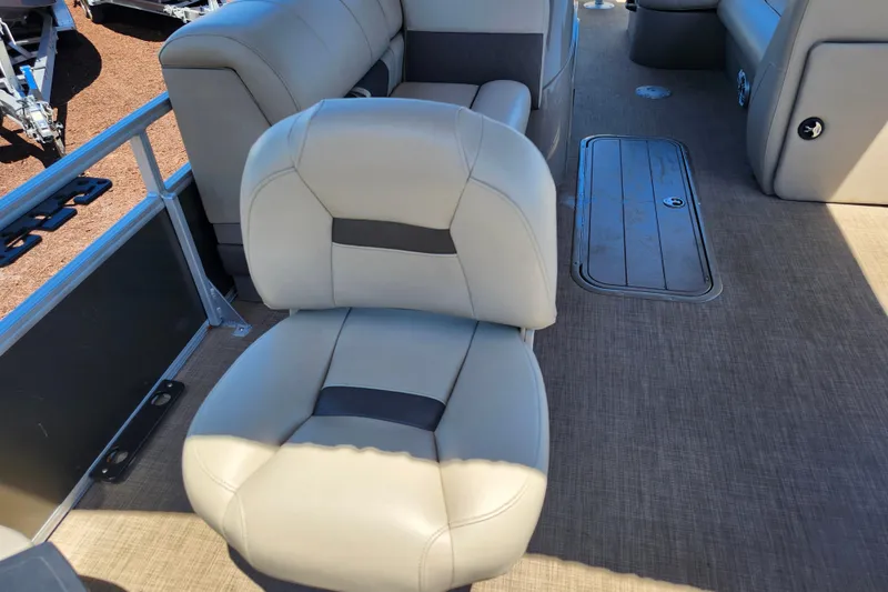 Slide: The Image of 2023 Sun Tracker Fishin' Barge 22 XP3 interior with beige seating and deck. - 25