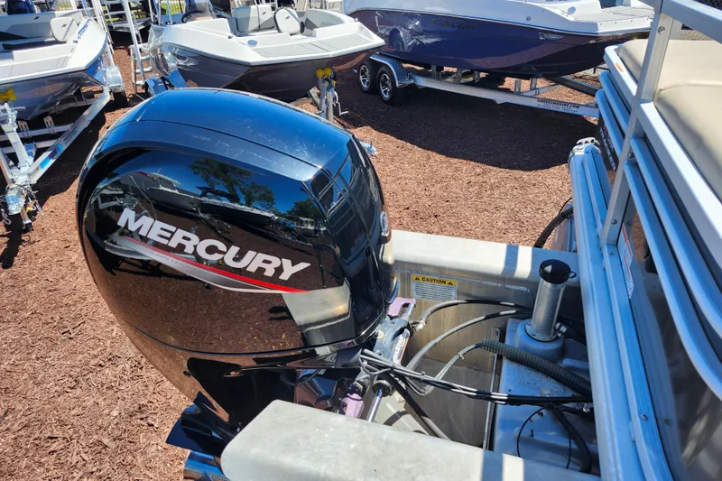 Slide: The Image of 2023 Sun Tracker Fishin' Barge 22 XP3 with Mercury outboard motor, displayed outdoors. - 28