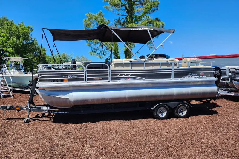 Slide: The Image of 2023 Sun Tracker Fishin' Barge 22 XP3 pontoon boat with canopy on trailer. - 3
