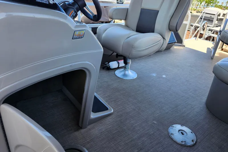 Slide: The Image of 2023 Sun Tracker Fishin' Barge 22 XP3 interior with seating and helm details. - 32