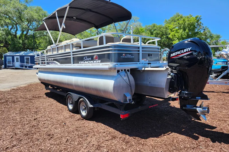Slide: The Image of 2023 Sun Tracker Fishin' Barge 22 XP3 pontoon boat with Mercury engine on trailer. - 4