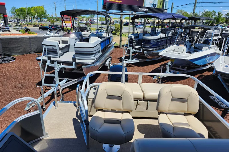 Slide: The Image of 2023 Sun Tracker Fishin' Barge 22 XP3 pontoon boats displayed at a dealership. - 7