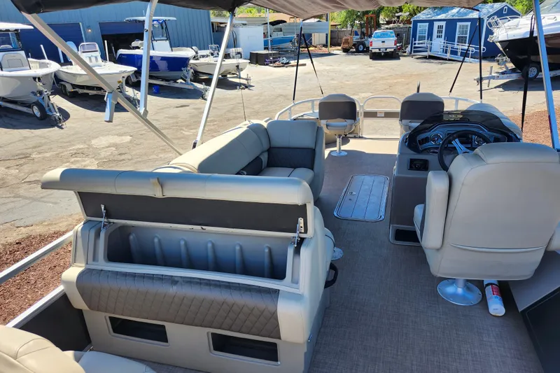 Slide: The Image of 2023 Sun Tracker Fishin' Barge 22 XP3 interior with seating and steering console. - 8