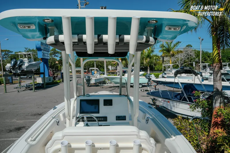 Slide: The Image of 2026 Key West 239 FS boat at dealership, showcasing helm and T-top design. - 10