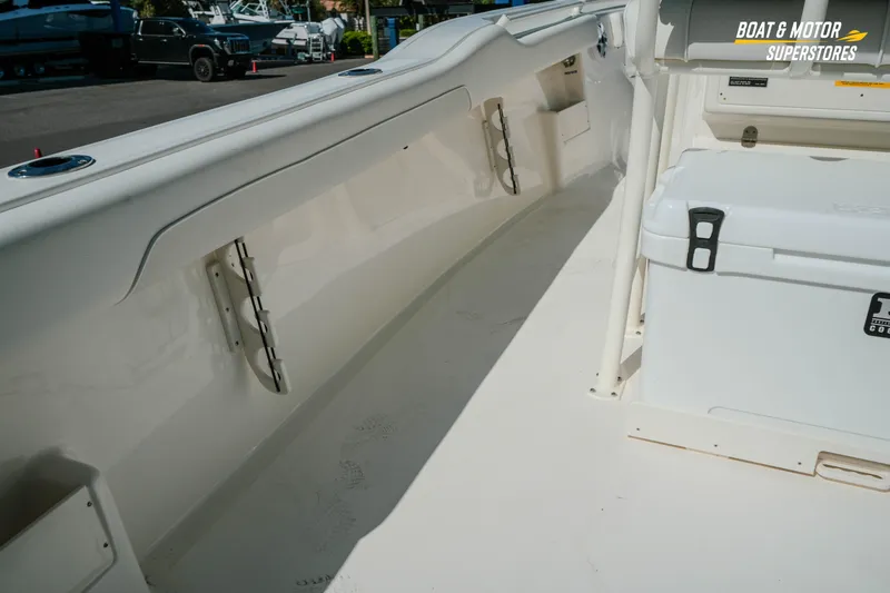 Slide: The Image of 2026 Key West 239 FS boat interior with storage and cooler, showcased at dealership. - 11