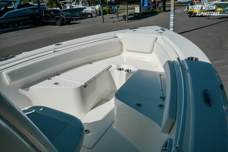 Slide: The Image of 2026 Key West 239 FS boat interior with seating and cup holders in a showroom. - 15