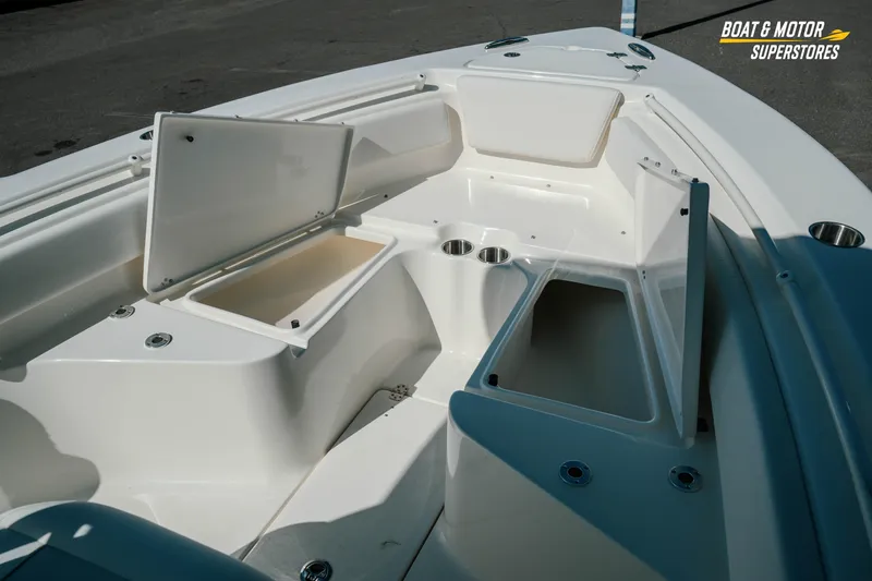 Slide: The Image of 2026 Key West 239 FS boat interior with open storage compartments and cup holders. - 18