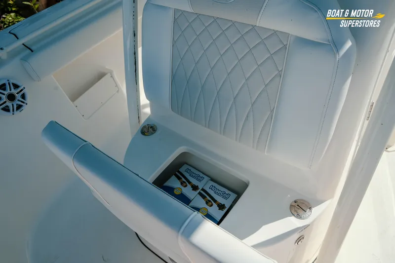 Slide: The Image of 2026 Key West 239 FS boat interior with storage compartment and white cushioned seating. - 19
