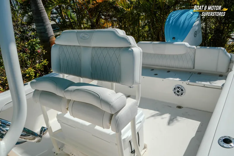 Slide: The Image of 2026 Key West 239 FS boat interior with white cushioned seating and console. - 21