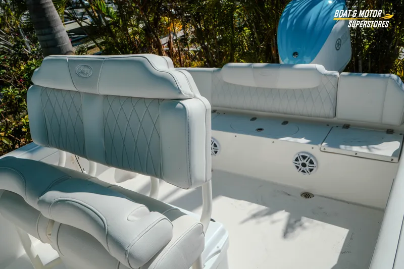 Slide: The Image of 2026 Key West 239 FS boat interior with white cushioned seating and storage compartments. - 22