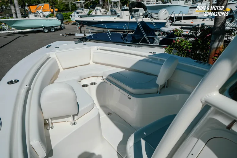 Slide: The Image of 2026 Key West 239 FS boat interior with white seating and cup holders. - 25