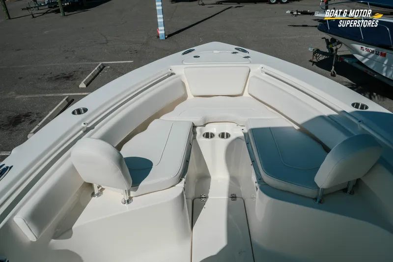 Slide: The Image of 2026 Key West 239 FS boat interior with white seating and cup holders. - 26