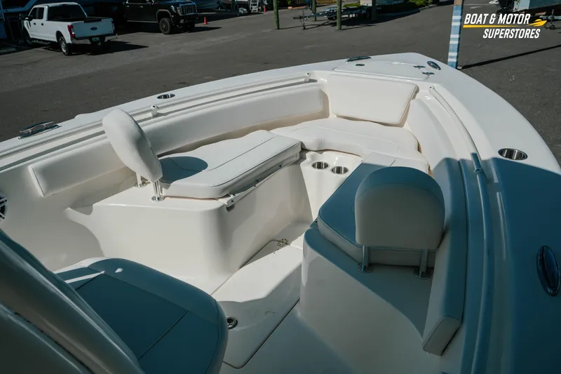Slide: The Image of 2026 Key West 239 FS boat interior with white seating and cup holders. - 27
