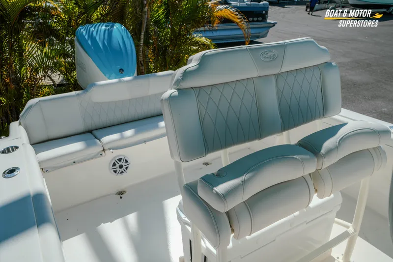 Slide: The Image of 2026 Key West 239 FS boat interior with white cushioned seating and motor. - 28