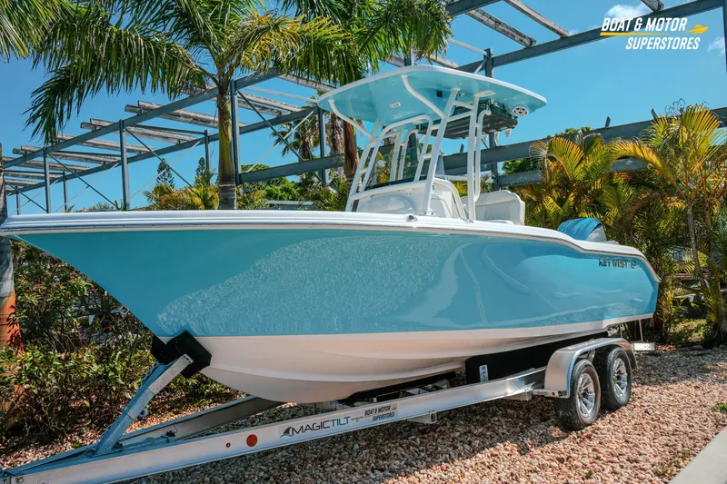Slide: The Image of 2026 Key West 239 FS boat on trailer, surrounded by tropical plants. - 3
