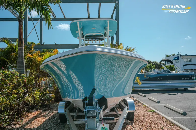 Slide: The Image of 2026 Key West 239 FS boat on trailer at dealership, surrounded by palm trees. - 4