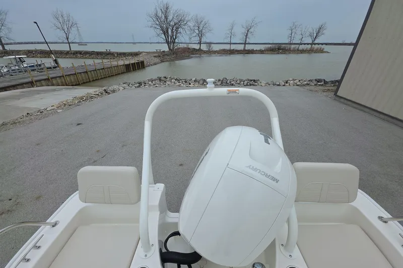 Slide: The Image of 2026 Boston Whaler 190 Montauk boat with Mercury engine at a lakeside dock. - 12