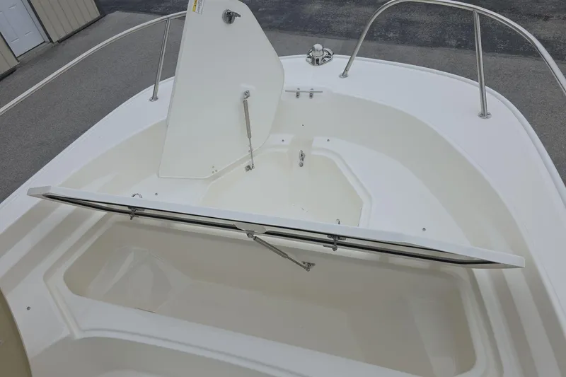 Slide: The Image of 2026 Boston Whaler 190 Montauk boat storage compartment open on deck. - 14