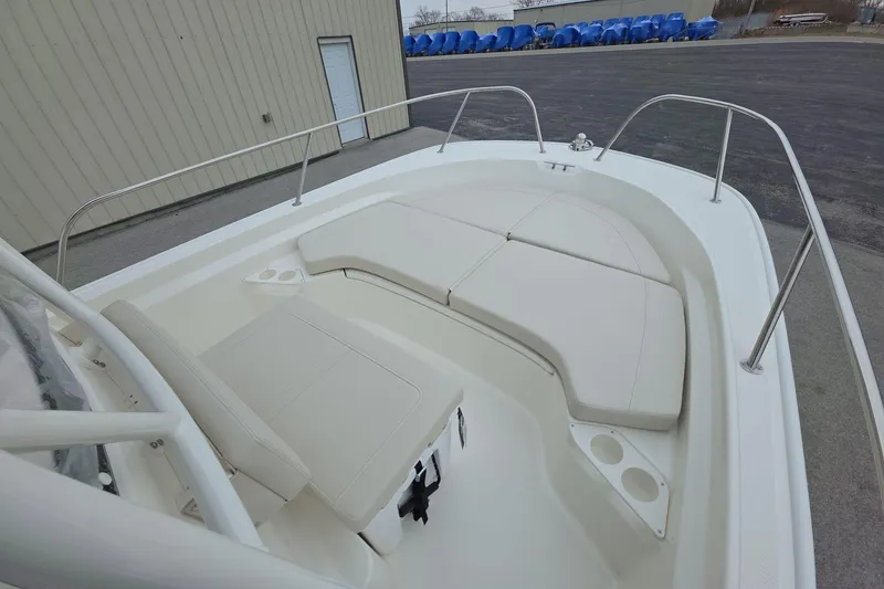 Slide: The Image of 2026 Boston Whaler 190 Montauk boat interior with cushioned seating and cup holders. - 15