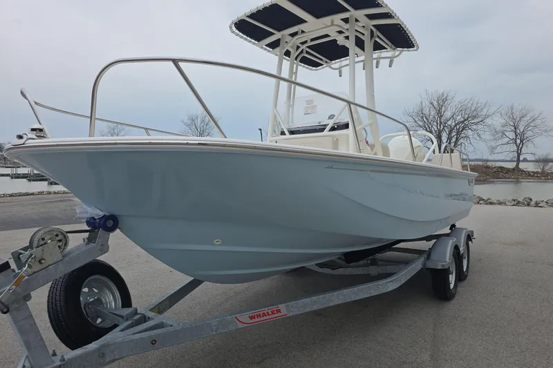 Slide: The Image of 2026 Boston Whaler 190 Montauk boat on trailer, parked near a waterfront. - 4