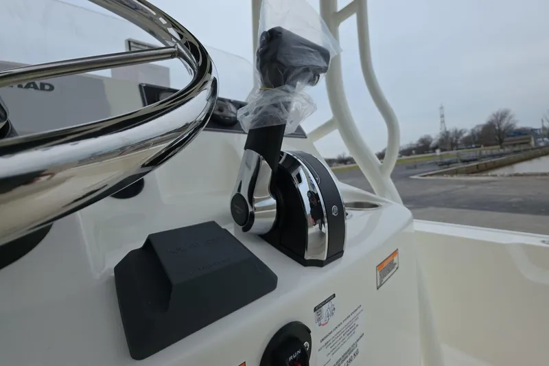 Slide: The Image of 2026 Boston Whaler 190 Montauk boat controls and steering wheel close-up. - 8