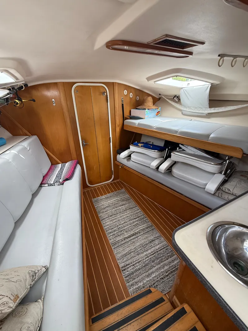 Slide: The Image of Interior of 2000 Luhrs Tournament 290 Open with wood flooring and seating area. - 10