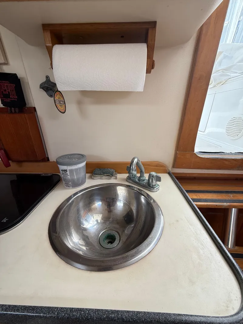 Slide: The Image of Galley area of 2000 Luhrs Tournament 290 Open with sink and paper towel holder. - 13