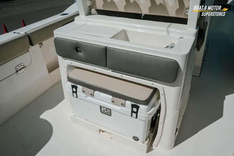 Slide: The Image of 2026 Key West 260 Center Console boat interior with storage and cooler. - 12