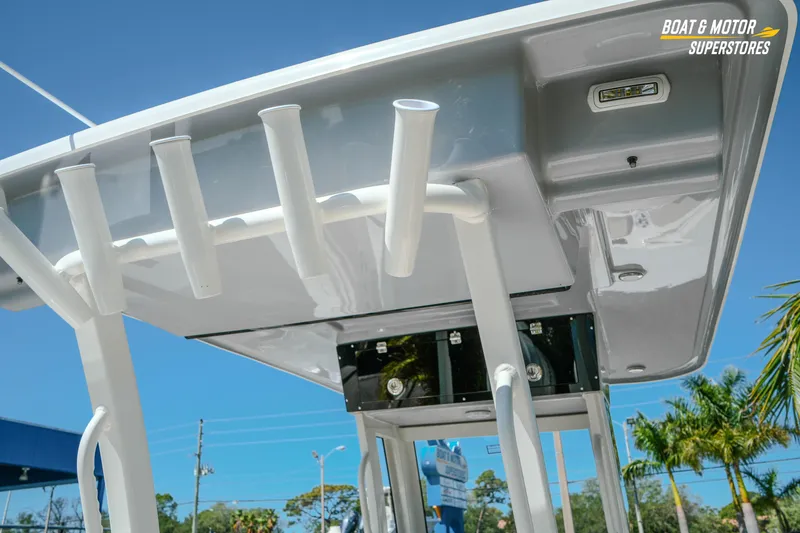 Slide: The Image of 2026 Key West 260 Center Console boat with rod holders and canopy, under clear blue sky. - 14