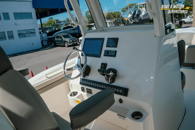 Slide: The Image of 2026 Key West 260 Center Console boat dashboard with steering wheel and controls. - 16