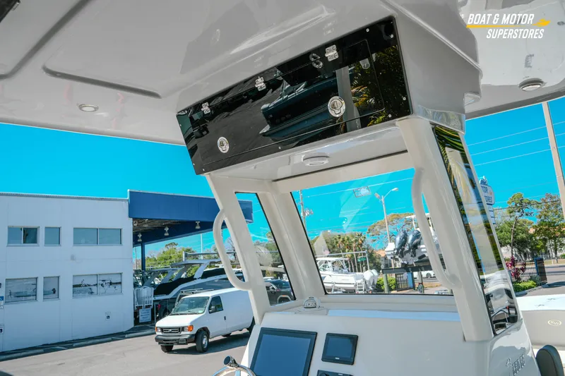 Slide: The Image of 2026 Key West 260 Center Console boat interior with electronics, parked at dealership. - 17