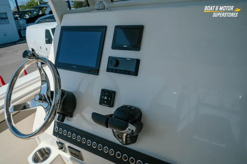 Slide: The Image of 2026 Key West 260 Center Console boat dashboard with steering wheel and electronic displays. - 18