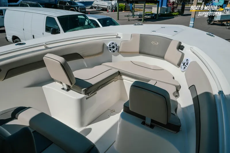 Slide: The Image of 2026 Key West 260 Center Console boat interior with cushioned seating and speakers. - 24