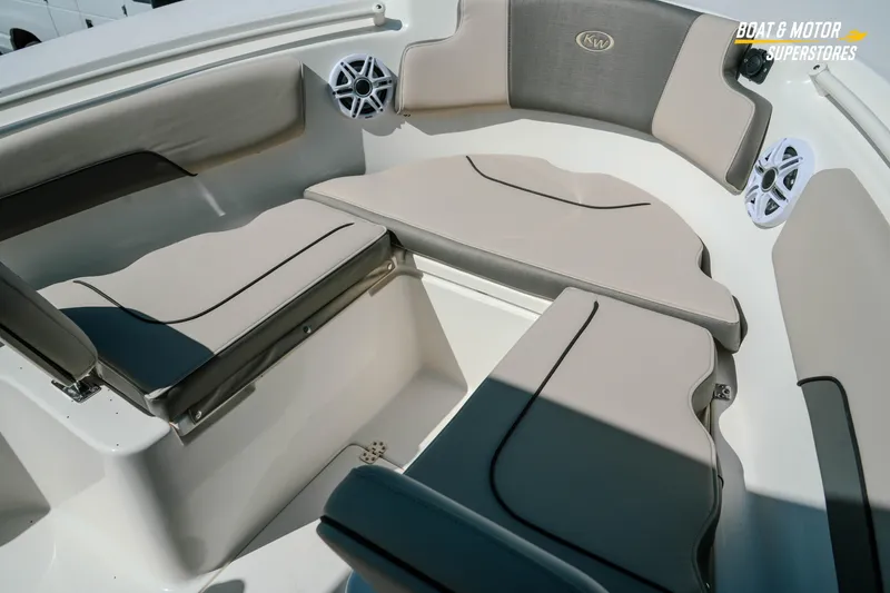 Slide: The Image of 2026 Key West 260 Center Console boat interior with cushioned seating and speakers. - 25